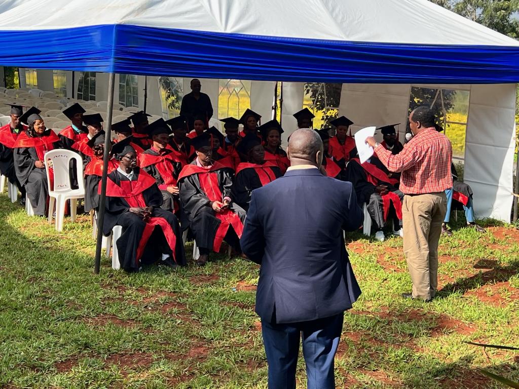 Graduates seated under tent