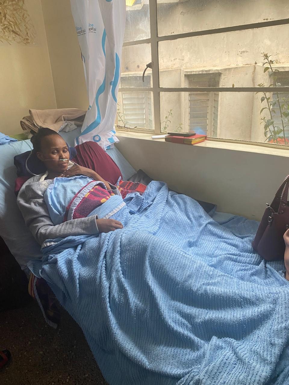 Anita resting in her hospital bed